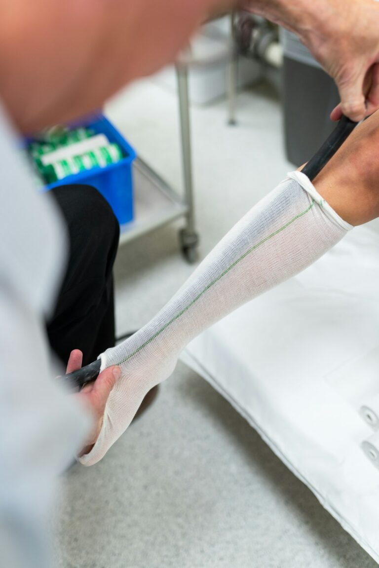 Orthotic technician measuring a patient's leg, relevant to ankle and foot arthritis care
