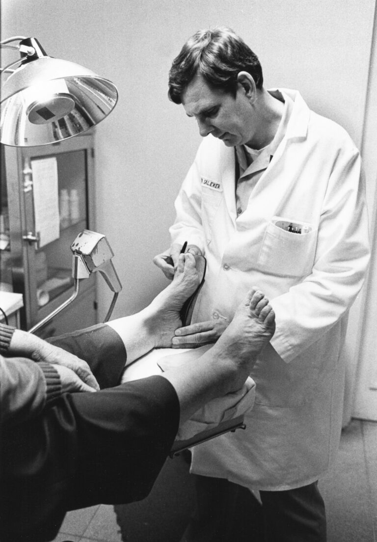 Podiatrist treating a patient at a clinic, relevant to bunion care