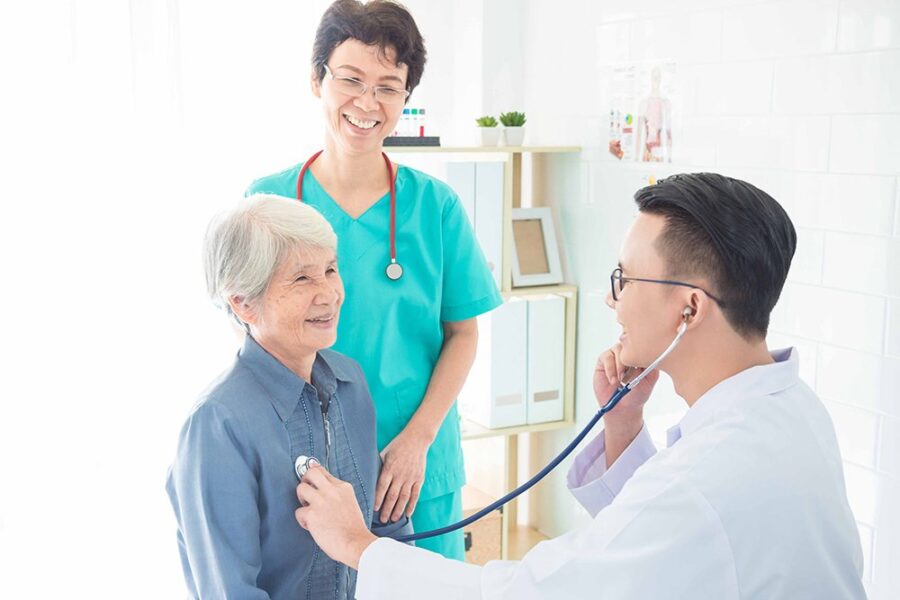 Doctor, nurse, and patient reviewing chronic care plan
