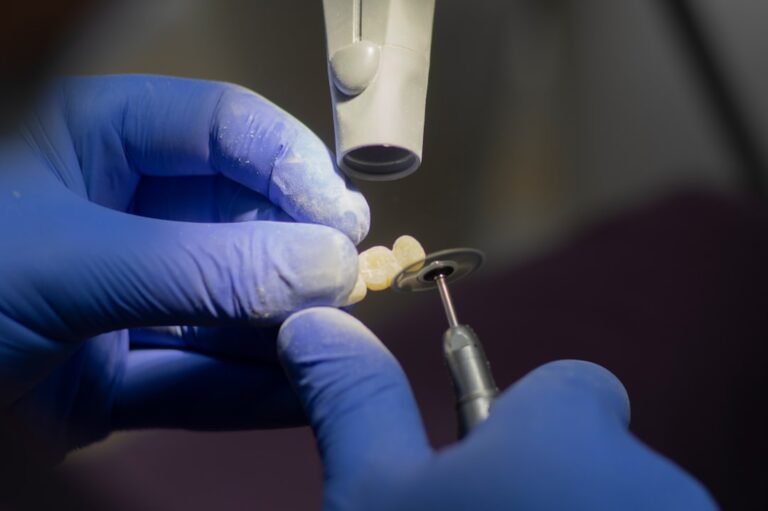 Dentist preparing a temporary crown for a patient