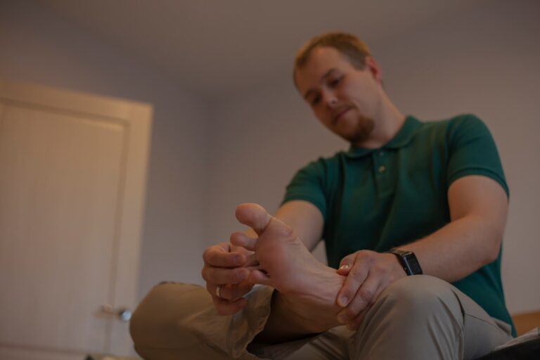 Adult man examining his own foot, representing a foot health evaluation