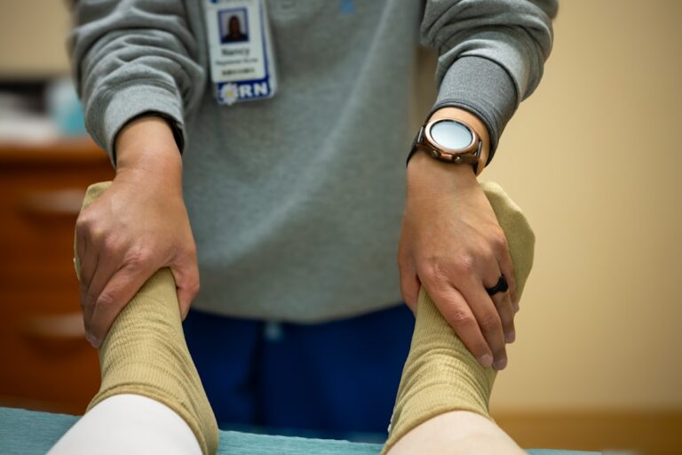 Nurse checking circulation and pulse in a patient's feet