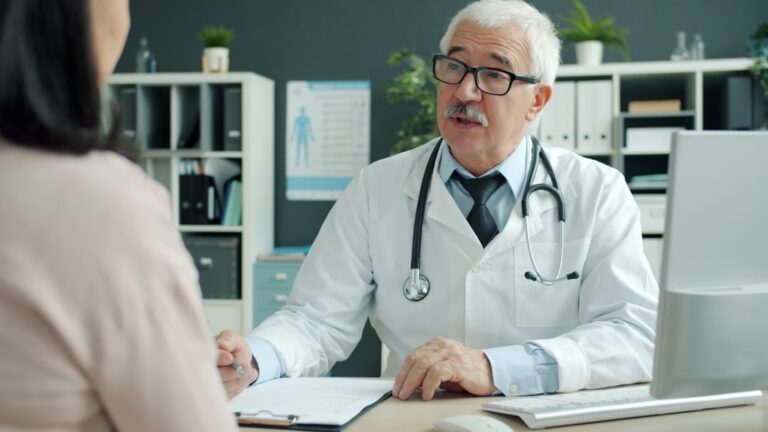 Doctor talking with a female patient during a gynecological care appointment