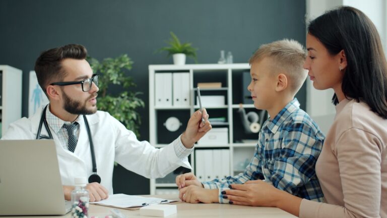 Pediatrician talking with a family during a health education visit