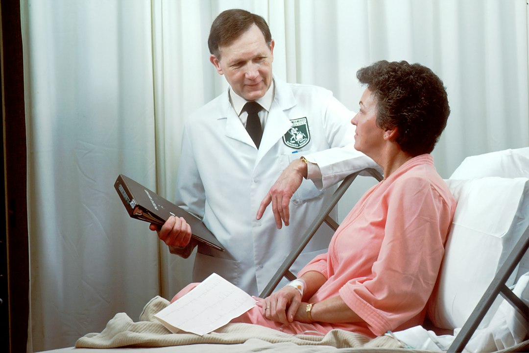 Medical assistant checking patient vitals