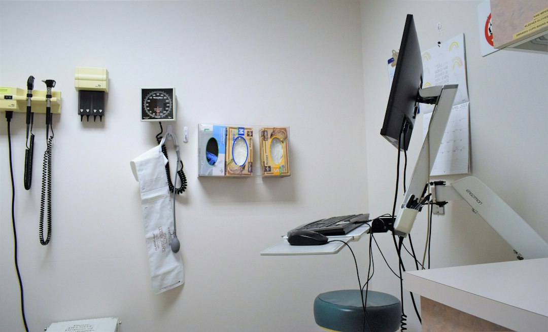Medical receptionist working at the front desk computer
