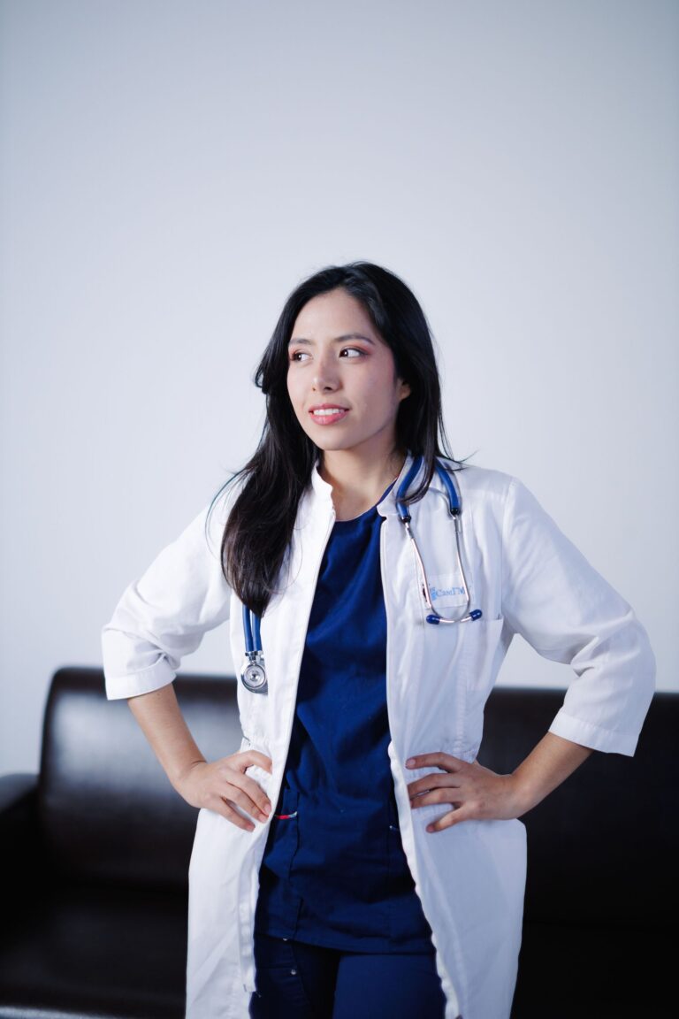 A healthcare professional in a white coat with a stethoscope around her neck