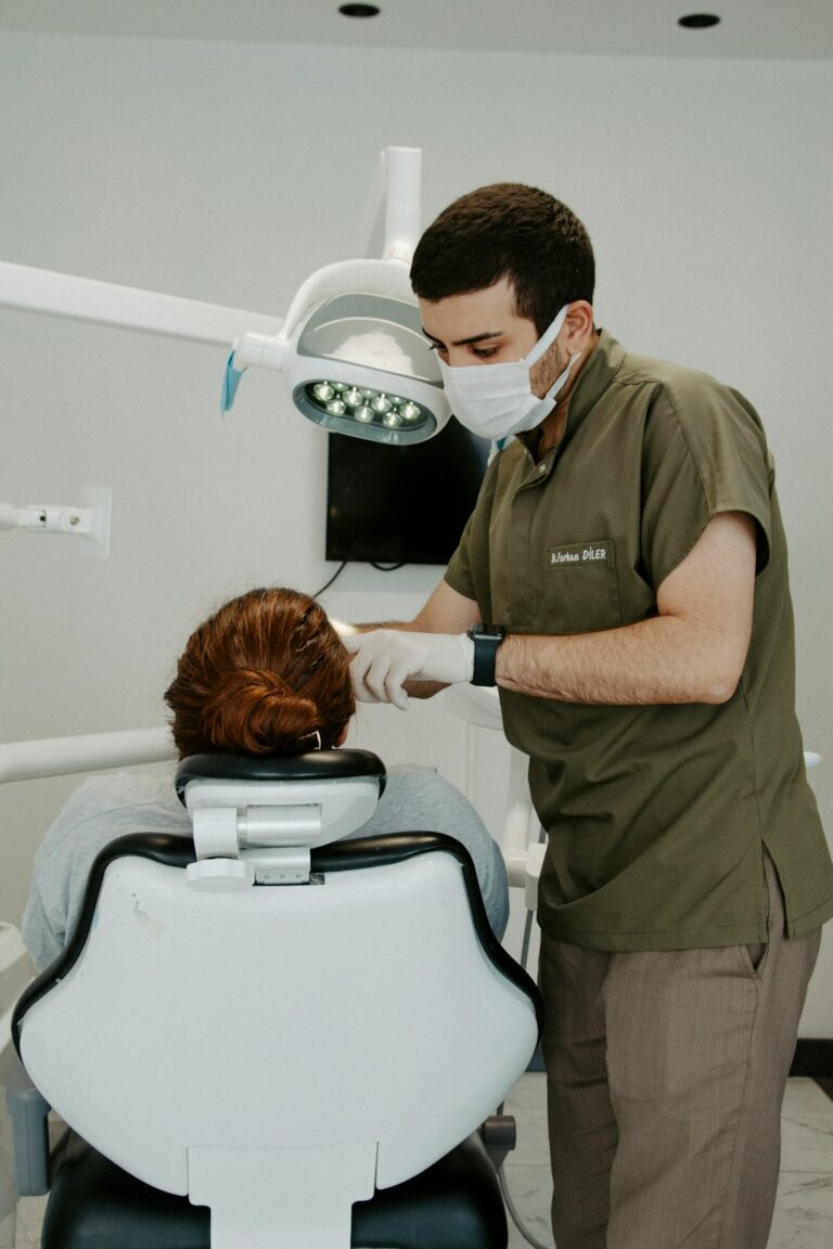Dentist examining a patient, relevant to postoperative dental pain care