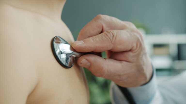 Doctor examining a child with a stethoscope during a preventive checkup