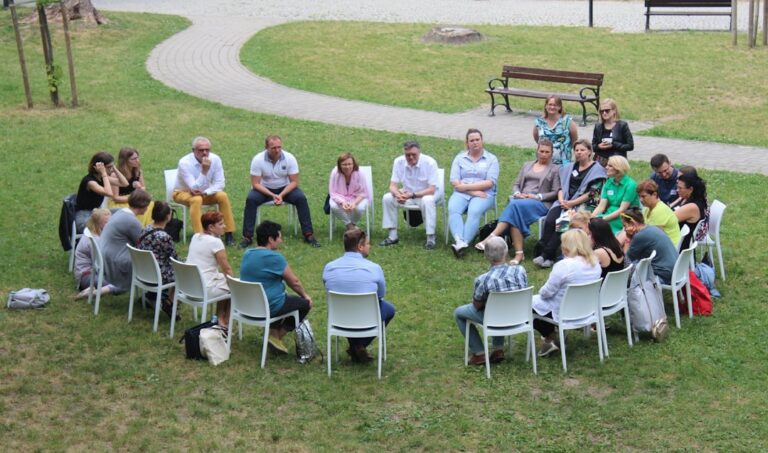Support group sitting together in an outdoor circle